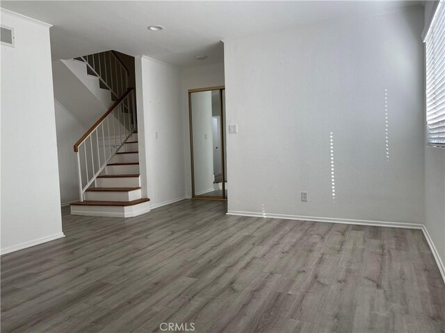 unfurnished room with hardwood / wood-style floors