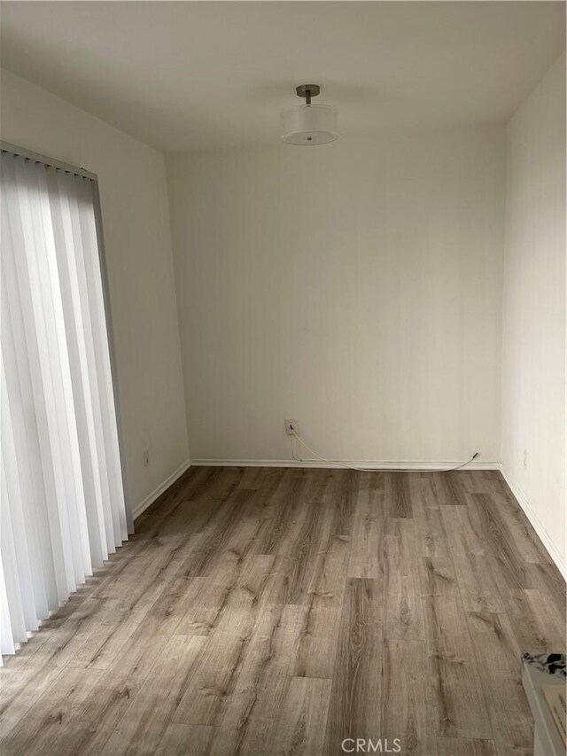 unfurnished room with light hardwood / wood-style floors