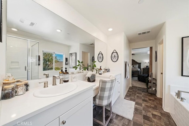 bathroom with vanity and separate shower and tub