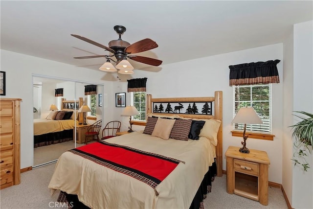 carpeted bedroom featuring a closet and ceiling fan