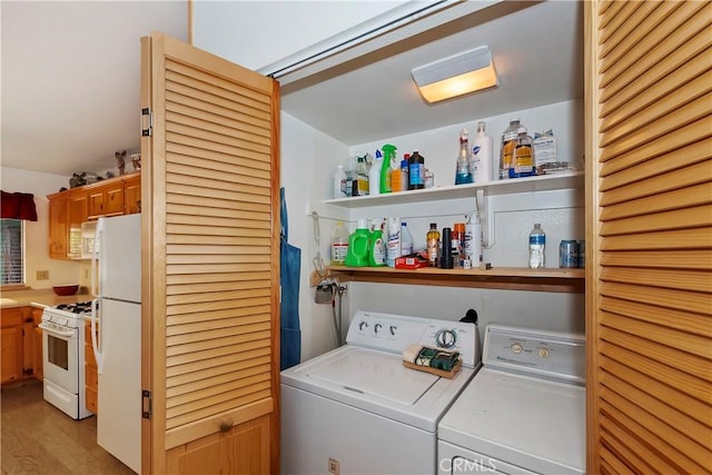 washroom with washer and dryer and light hardwood / wood-style floors