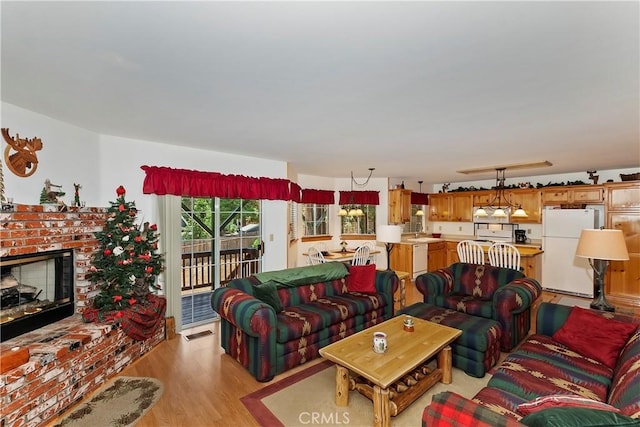 living room with light hardwood / wood-style floors and a fireplace