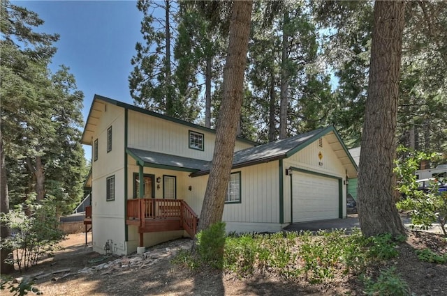 rear view of property featuring a porch and a garage