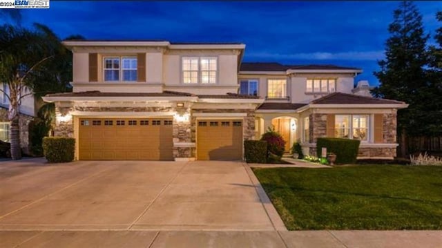 view of front of house with a front yard and a garage