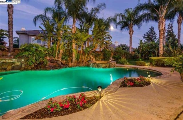 view of pool at dusk