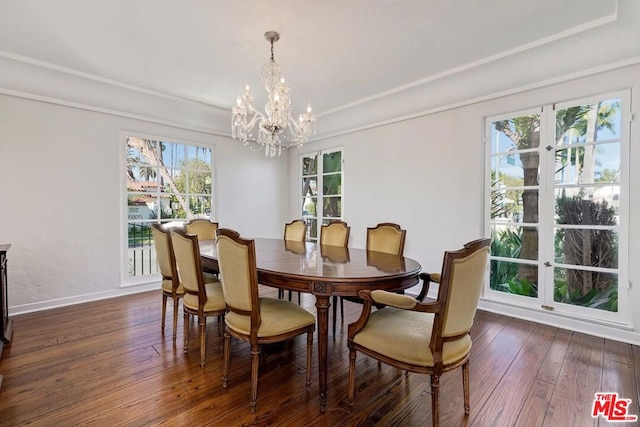 dining space with an inviting chandelier, plenty of natural light, and dark wood-type flooring