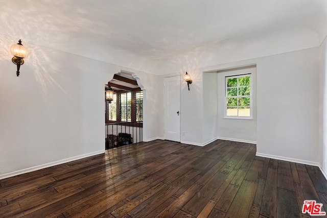 spare room featuring dark wood-type flooring