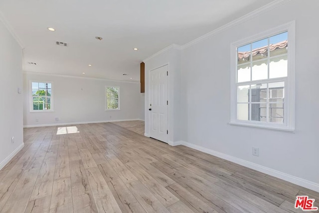 unfurnished room featuring light hardwood / wood-style floors and ornamental molding