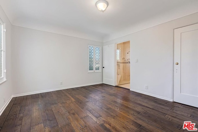 empty room featuring dark hardwood / wood-style flooring