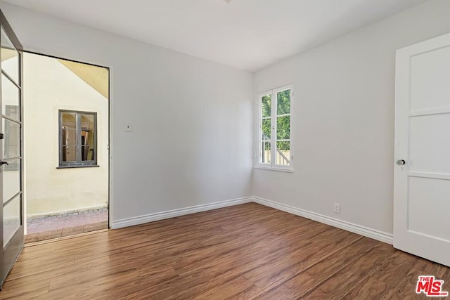 unfurnished room featuring hardwood / wood-style floors