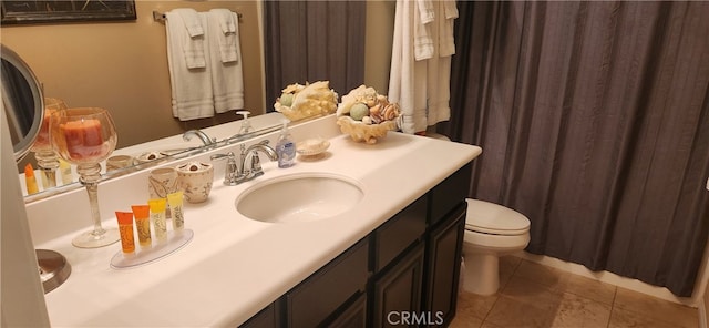 bathroom featuring tile patterned flooring, vanity, and toilet