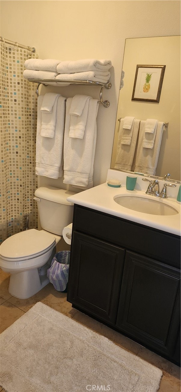 bathroom featuring tile patterned flooring, vanity, and toilet