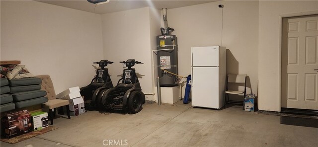 garage featuring water heater and white fridge