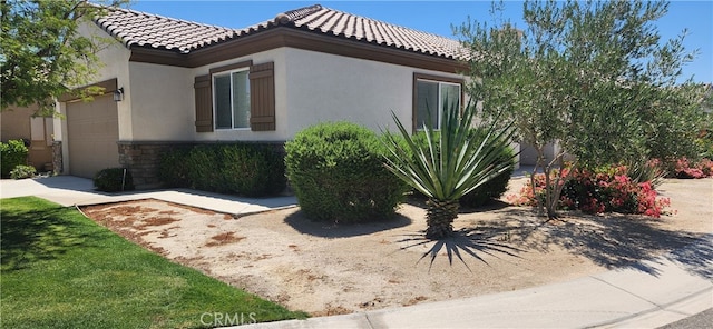 view of home's exterior featuring a garage and a yard