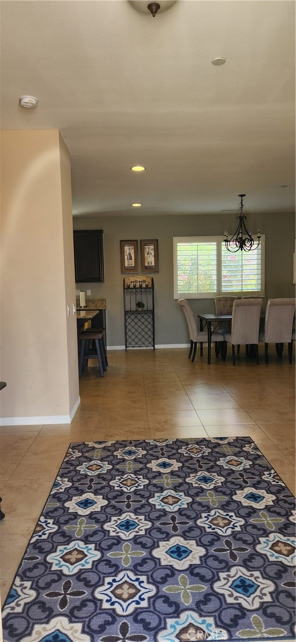 entrance foyer with tile patterned flooring and a notable chandelier