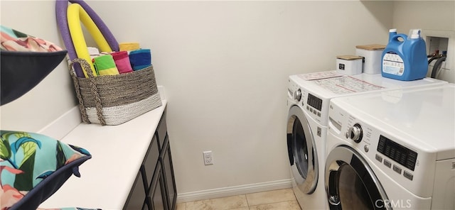 washroom with light tile patterned floors and washing machine and clothes dryer