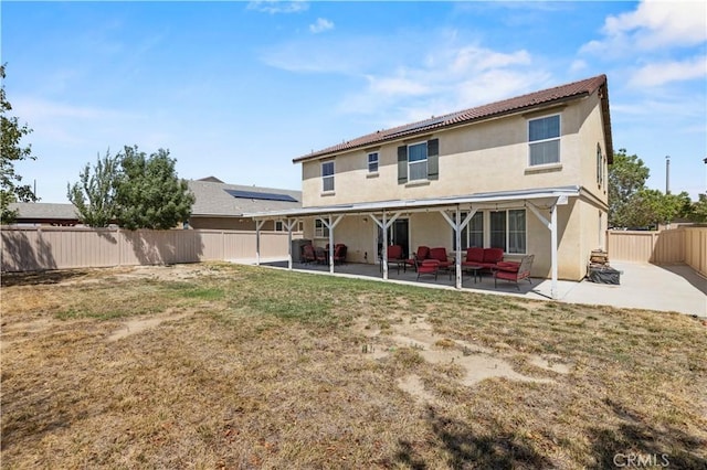 back of property featuring an outdoor living space, a patio, and a lawn