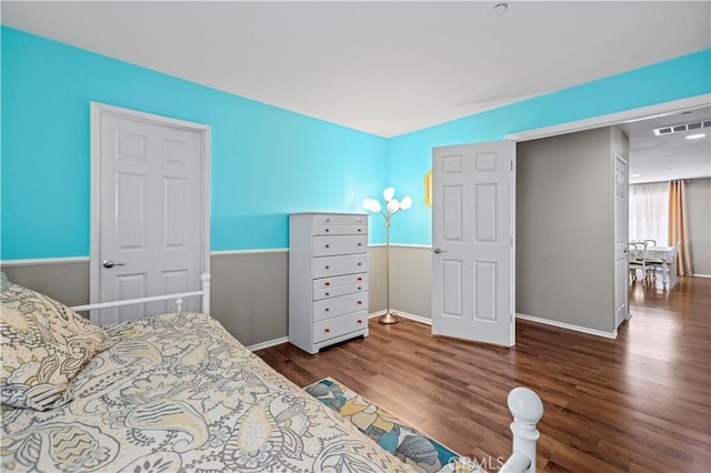 bedroom with dark hardwood / wood-style flooring