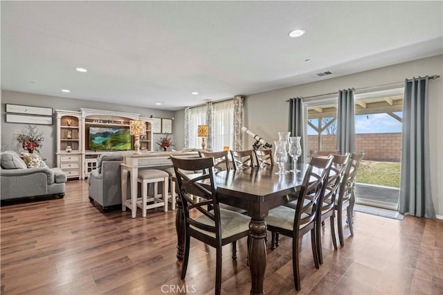 dining area with hardwood / wood-style floors