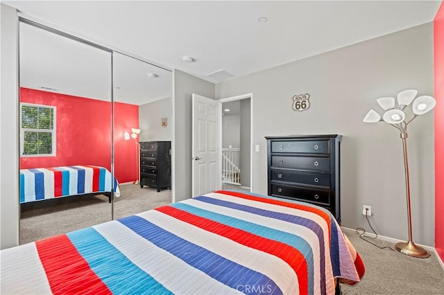 bedroom featuring light colored carpet and a closet