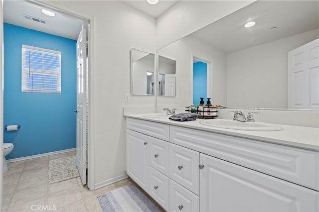 bathroom with tile patterned floors, vanity, and toilet