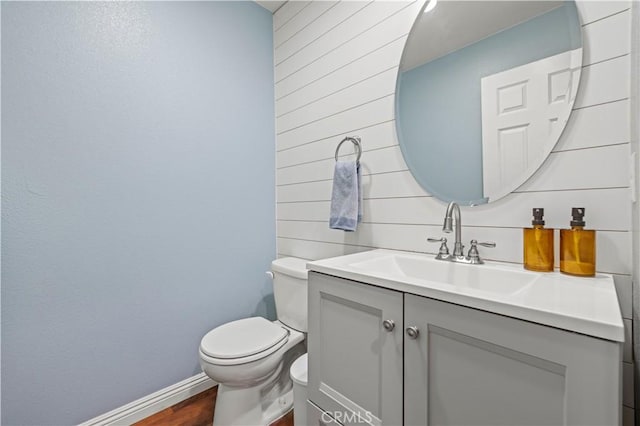 bathroom featuring hardwood / wood-style flooring, vanity, and toilet