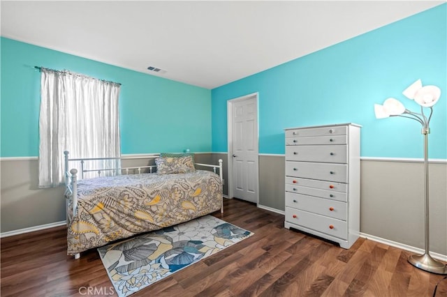 bedroom with dark hardwood / wood-style flooring