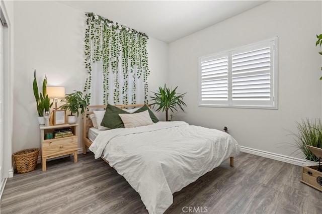 bedroom with dark hardwood / wood-style flooring