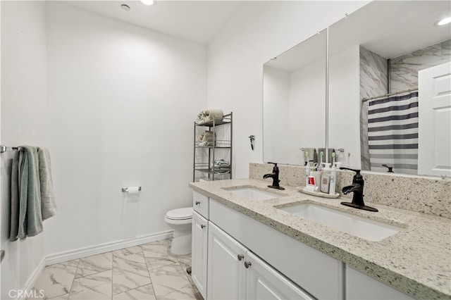 bathroom featuring vanity, toilet, and curtained shower