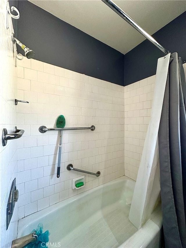 bathroom with shower / bath combination with curtain