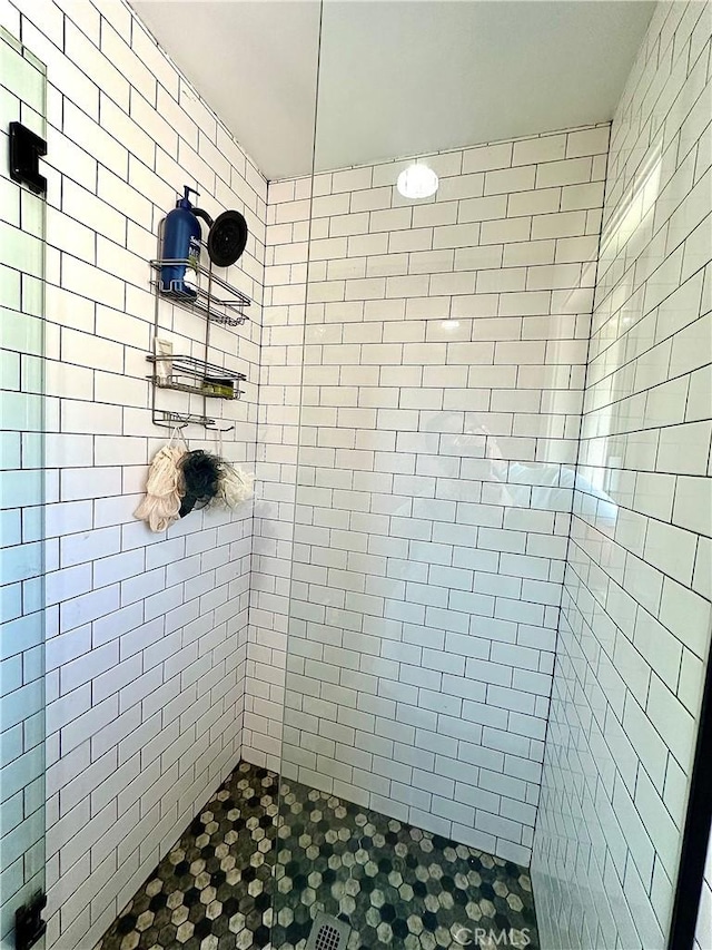 bathroom with tiled shower