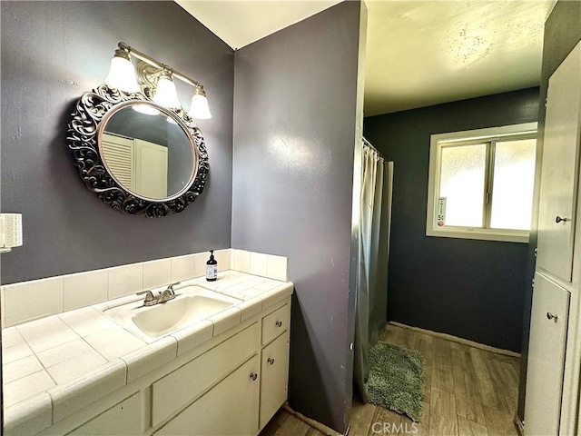 bathroom featuring hardwood / wood-style flooring and vanity