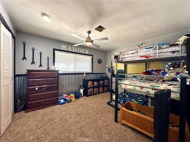 bedroom featuring ceiling fan and light carpet