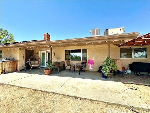 back of house featuring a patio area and cooling unit