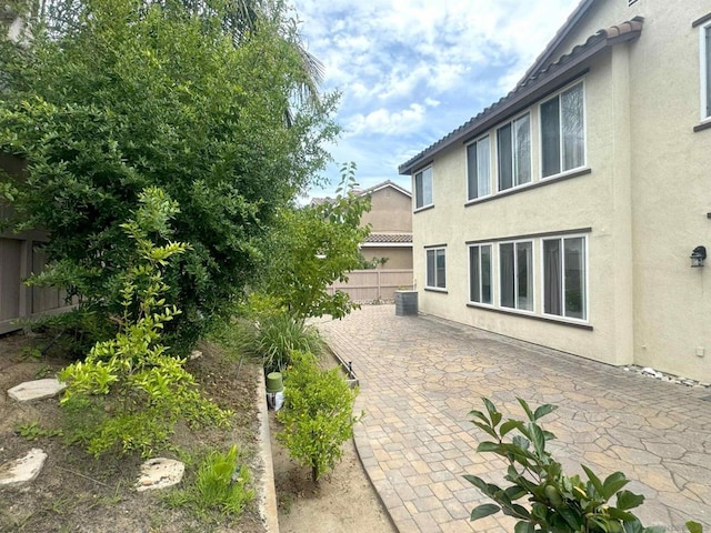 view of yard with a patio area and central air condition unit