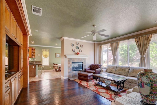 living room featuring a textured ceiling, a fireplace, and dark hardwood / wood-style flooring