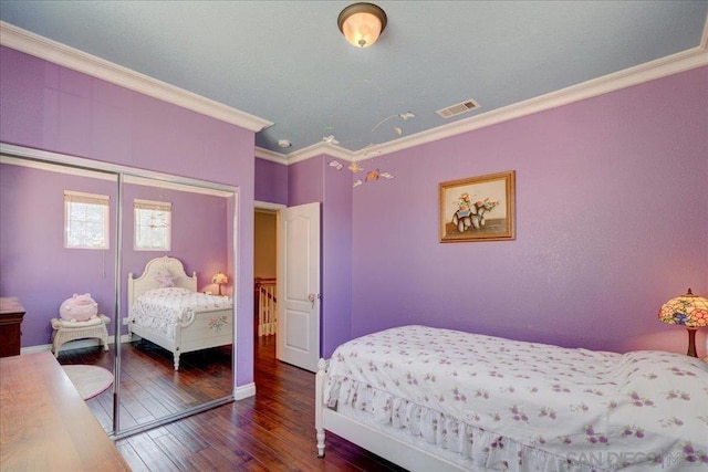 bedroom featuring ornamental molding, dark hardwood / wood-style flooring, and a closet