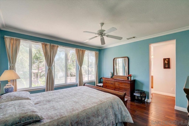 bedroom with multiple windows, ornamental molding, dark hardwood / wood-style flooring, and ceiling fan