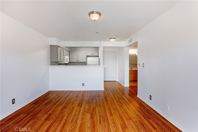 unfurnished living room featuring hardwood / wood-style flooring