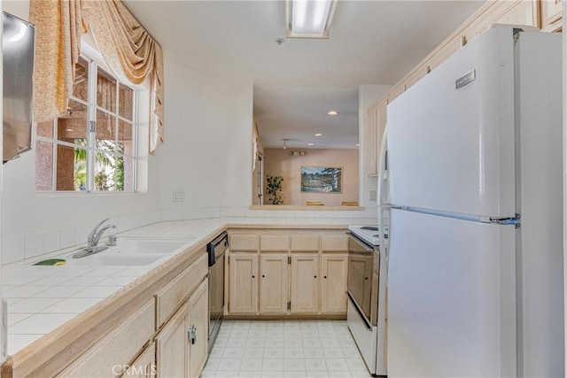 kitchen with white appliances, light brown cabinets, tile countertops, and sink