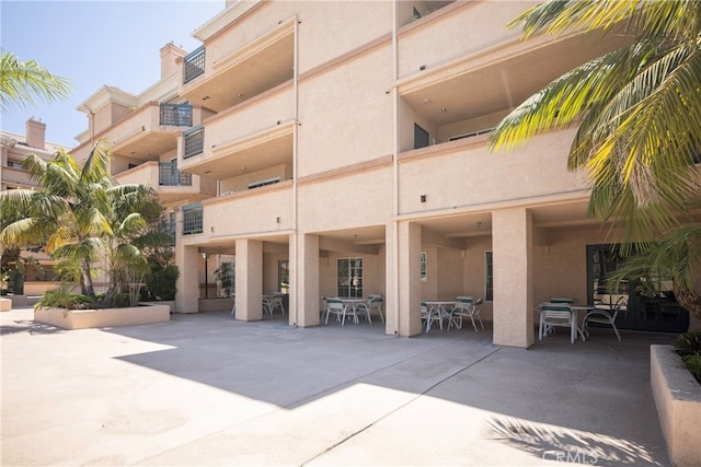 rear view of property with a balcony and a patio