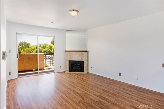 unfurnished living room with a fireplace and hardwood / wood-style floors