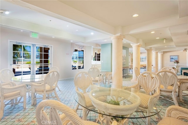 dining space featuring decorative columns