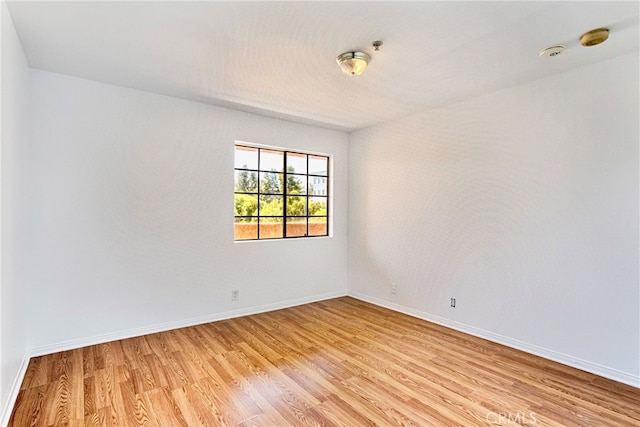 spare room with light hardwood / wood-style flooring