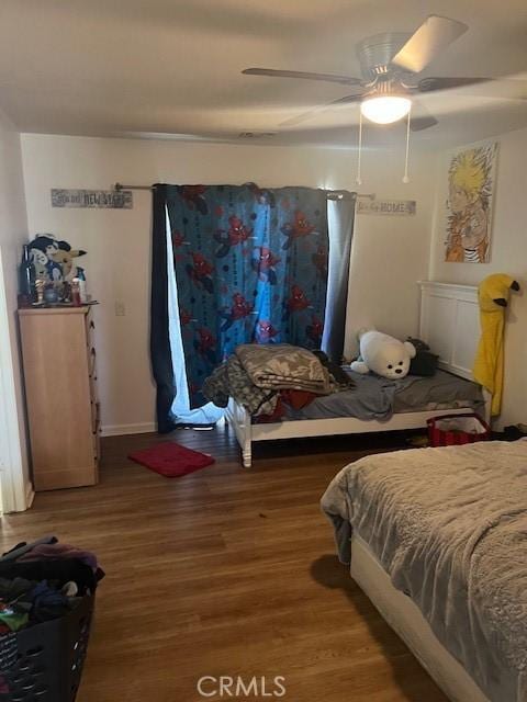 bedroom with hardwood / wood-style floors and ceiling fan