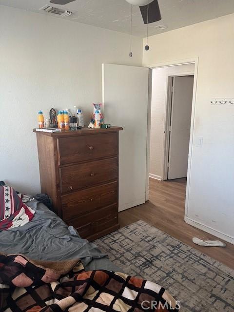 bedroom featuring hardwood / wood-style flooring and ceiling fan