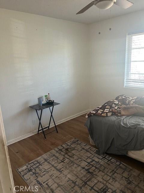 bedroom with dark wood-type flooring and ceiling fan