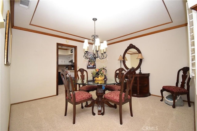 carpeted dining space featuring ornamental molding and a chandelier