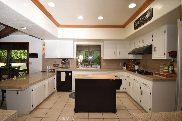 kitchen featuring black appliances, white cabinets, kitchen peninsula, and sink