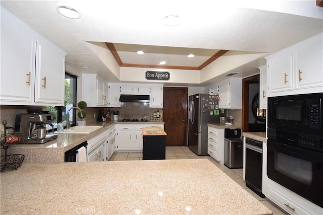 kitchen with a raised ceiling, black appliances, sink, light tile patterned floors, and white cabinetry